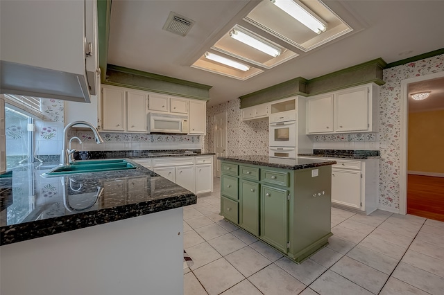 kitchen featuring green cabinets, white cabinetry, white appliances, and a kitchen island