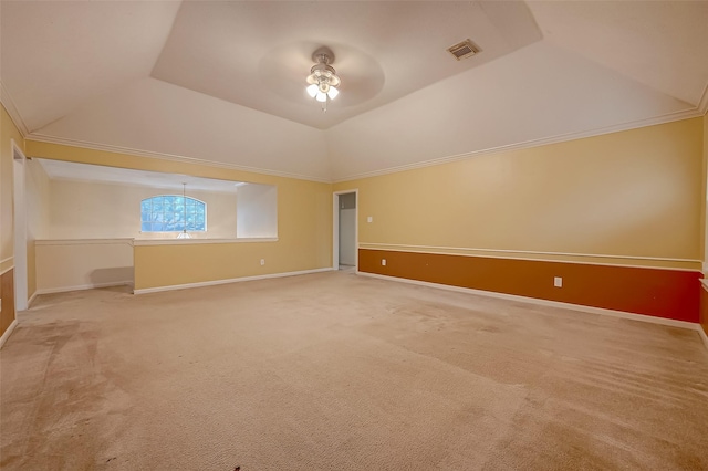 empty room with lofted ceiling, carpet flooring, ceiling fan, and baseboards