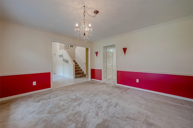 empty room featuring light tile patterned floors, a chandelier, light colored carpet, stairs, and crown molding