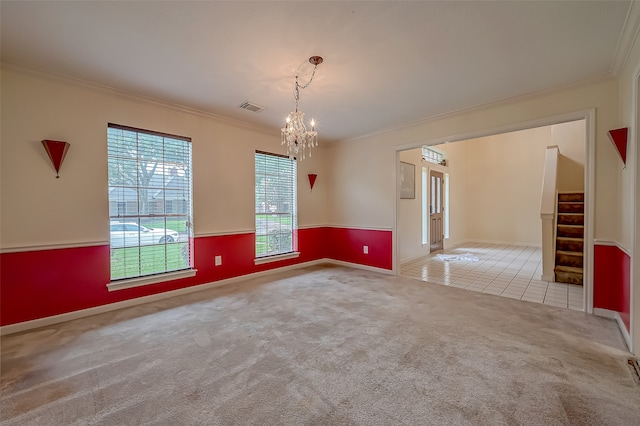 carpeted empty room with ornamental molding and a chandelier