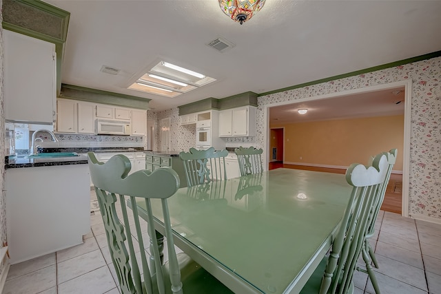 tiled dining room with sink