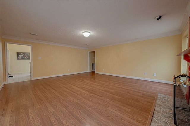 unfurnished living room featuring light hardwood / wood-style floors and crown molding