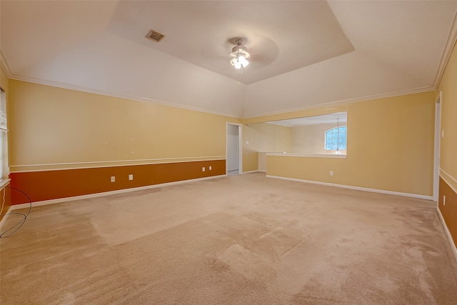 empty room with ornamental molding, ceiling fan, a raised ceiling, and carpet flooring