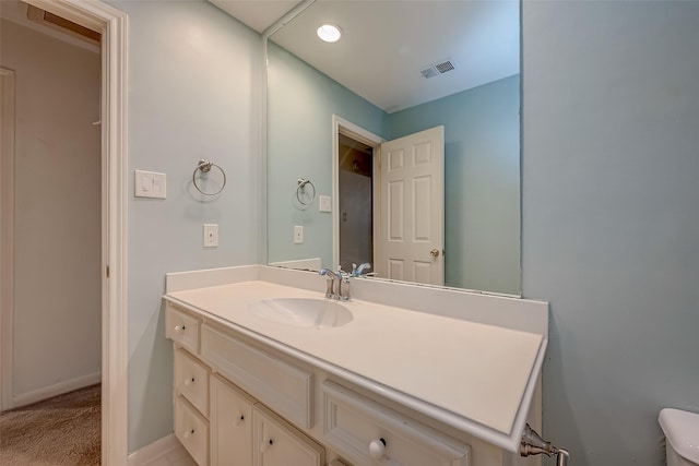 bathroom featuring vanity, visible vents, and baseboards