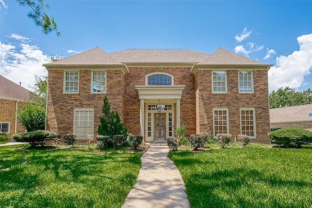 colonial inspired home featuring a front yard