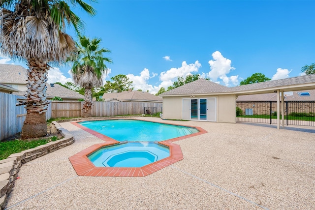 view of pool with a fenced in pool, a fenced backyard, a patio, and an in ground hot tub