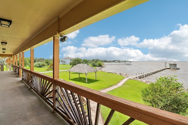 balcony featuring a water view and a boat dock