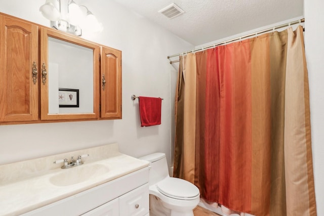 full bathroom with visible vents, a shower with shower curtain, toilet, vanity, and a textured ceiling