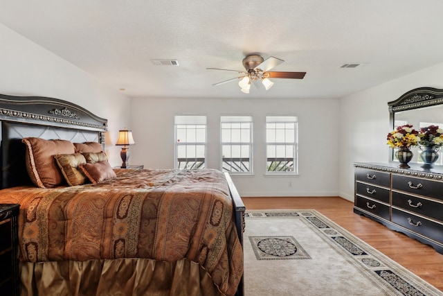 bedroom with ceiling fan and light wood-type flooring