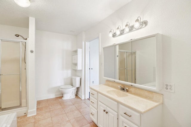 bathroom with toilet, vanity, baseboards, tile patterned floors, and a stall shower