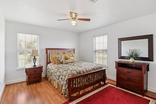 bedroom with ceiling fan and light wood-type flooring