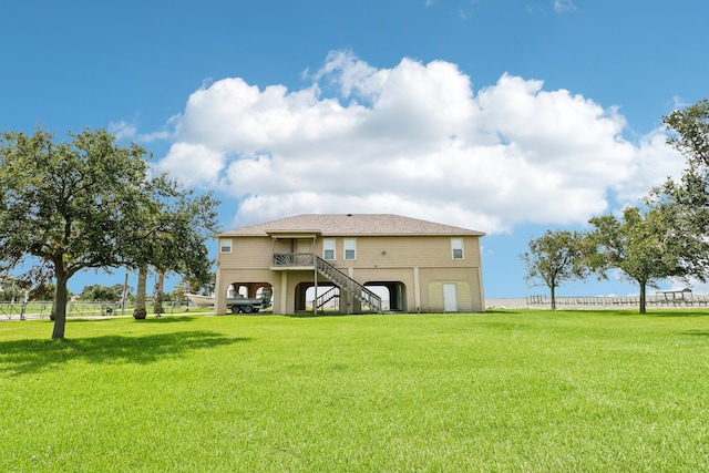 rear view of house featuring a deck and a lawn