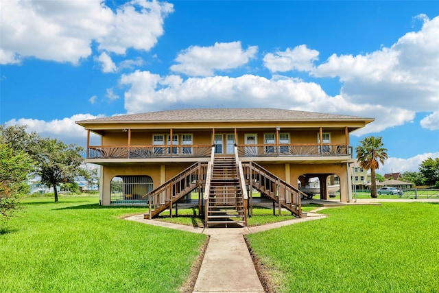 exterior space featuring a lawn, stairway, and stucco siding