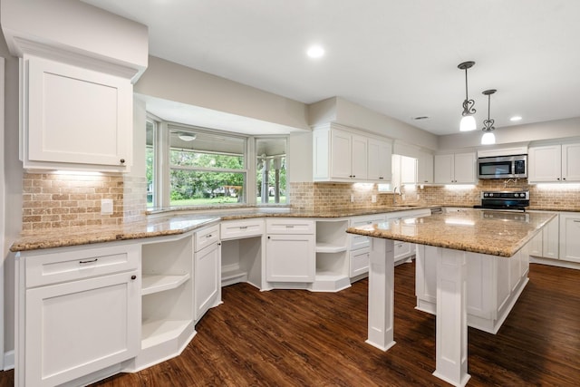 kitchen with range with electric stovetop, open shelves, stainless steel microwave, white cabinets, and a sink