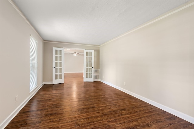 unfurnished room featuring dark wood-type flooring, french doors, visible vents, and baseboards