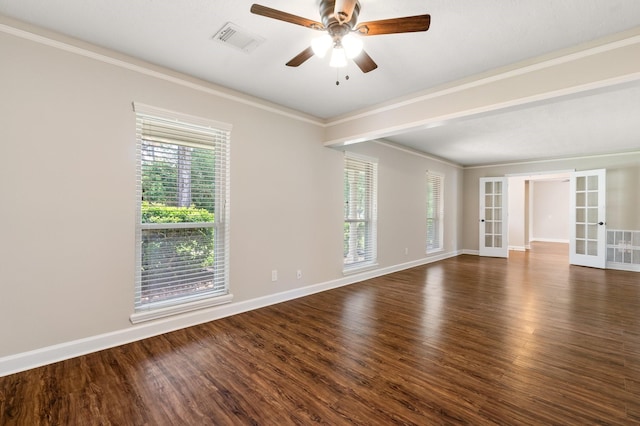 spare room featuring visible vents, dark wood finished floors, crown molding, and french doors