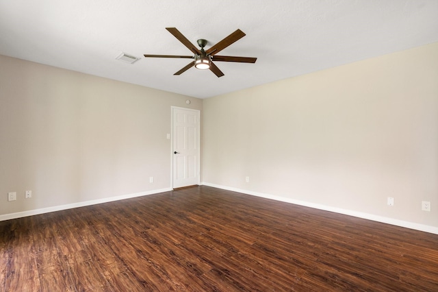 unfurnished room with a ceiling fan, dark wood-style flooring, visible vents, and baseboards