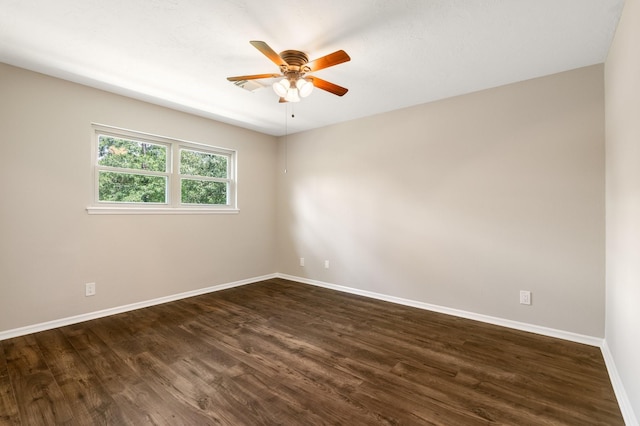 spare room featuring ceiling fan, baseboards, and dark wood-type flooring