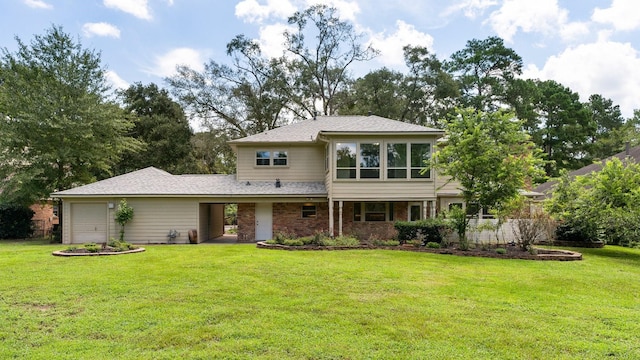 back of house with brick siding, a lawn, and an attached garage