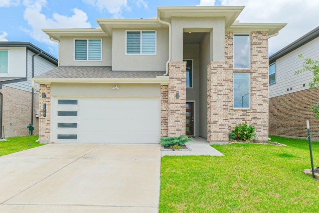 view of front of house with a garage and a front lawn