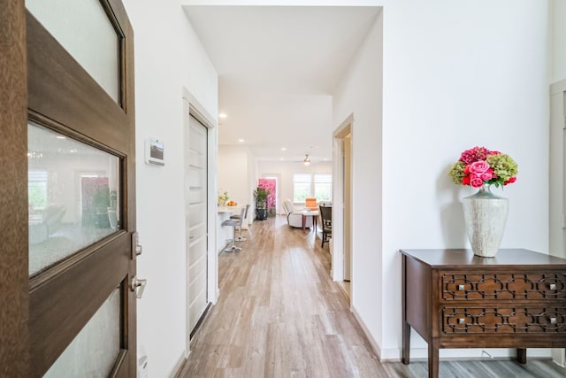 hallway with hardwood / wood-style floors