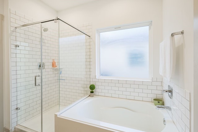 bathroom featuring a healthy amount of sunlight and a bathtub