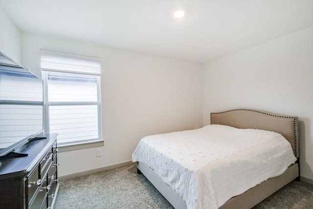 bedroom featuring light carpet