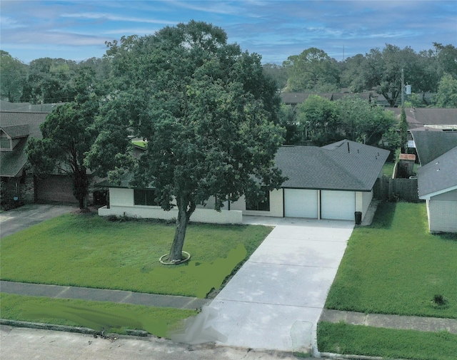 ranch-style house featuring a front yard and a garage