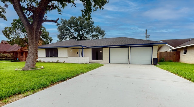 single story home featuring a front lawn and a garage