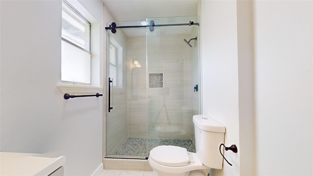 bathroom featuring an enclosed shower, vanity, toilet, and tile patterned flooring