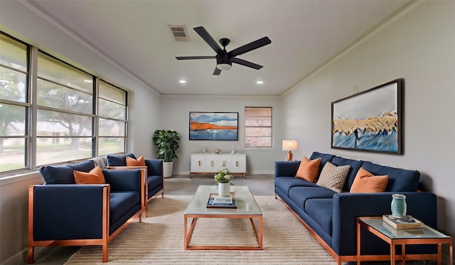 living room featuring ceiling fan and crown molding