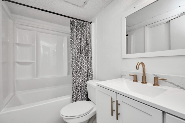 full bathroom featuring vanity, a textured ceiling, shower / bath combo, and toilet