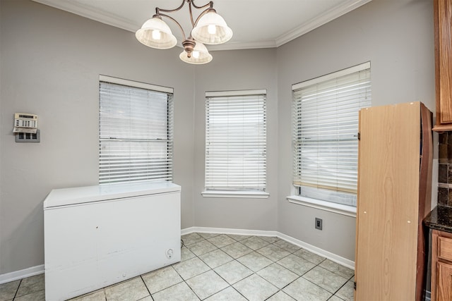 unfurnished dining area with a notable chandelier, light tile patterned floors, and crown molding