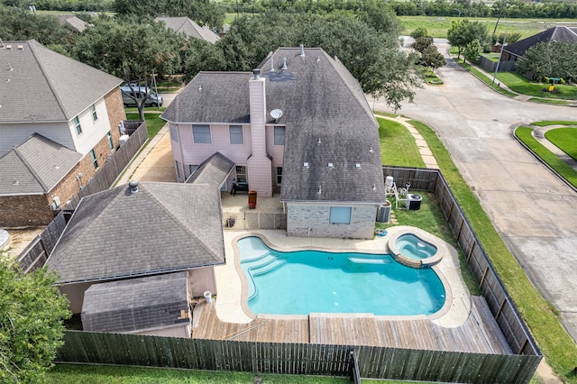 view of swimming pool featuring a patio and an in ground hot tub