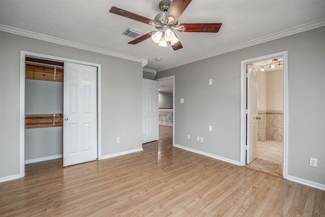 unfurnished bedroom featuring ensuite bathroom, crown molding, ceiling fan, and light hardwood / wood-style flooring