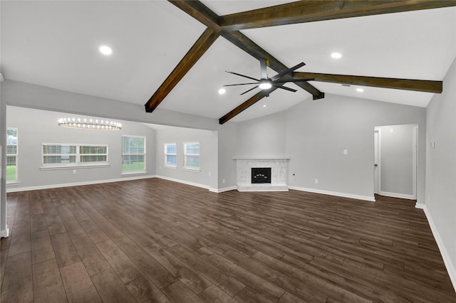 unfurnished living room featuring ceiling fan with notable chandelier, vaulted ceiling with beams, and dark hardwood / wood-style floors