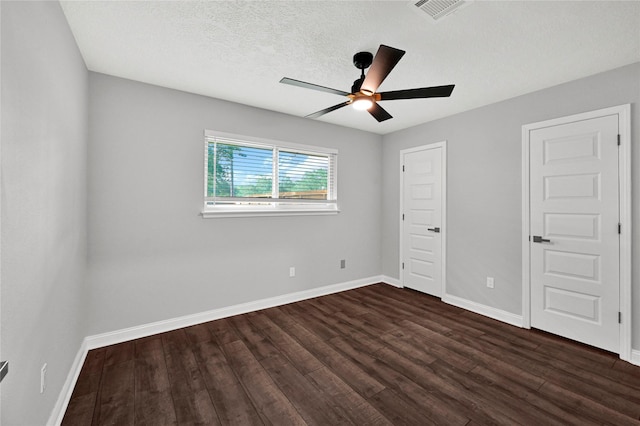 unfurnished bedroom featuring dark wood-type flooring and ceiling fan