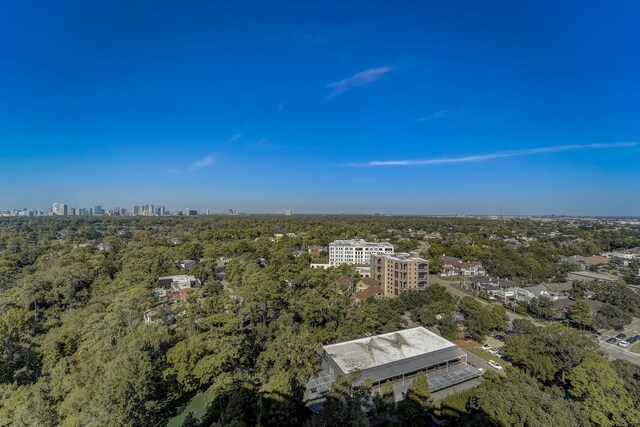 aerial view featuring a city view and a wooded view