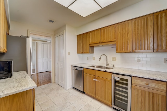 kitchen featuring wine cooler, tasteful backsplash, visible vents, stainless steel dishwasher, and a sink