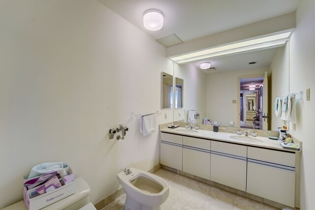 full bathroom featuring double vanity, tile patterned flooring, a bidet, and a sink