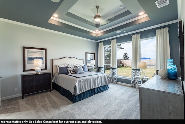 bedroom with ceiling fan, carpet flooring, crown molding, and a tray ceiling