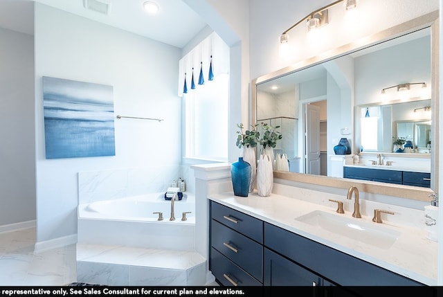 bathroom with tile patterned floors, a bathing tub, and vanity