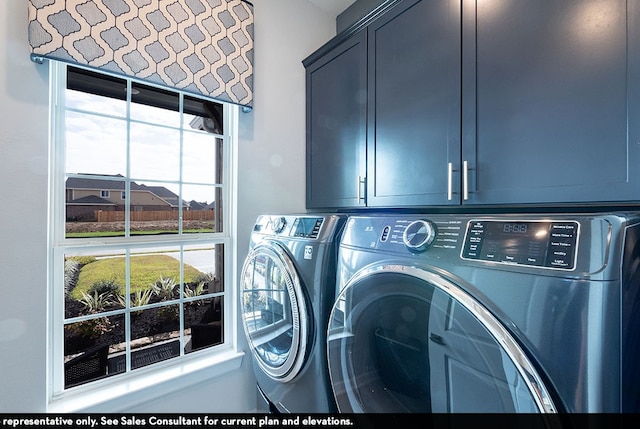 laundry area featuring washer and clothes dryer and cabinets