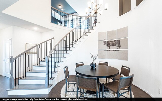 dining room featuring an inviting chandelier, a high ceiling, and wood-type flooring