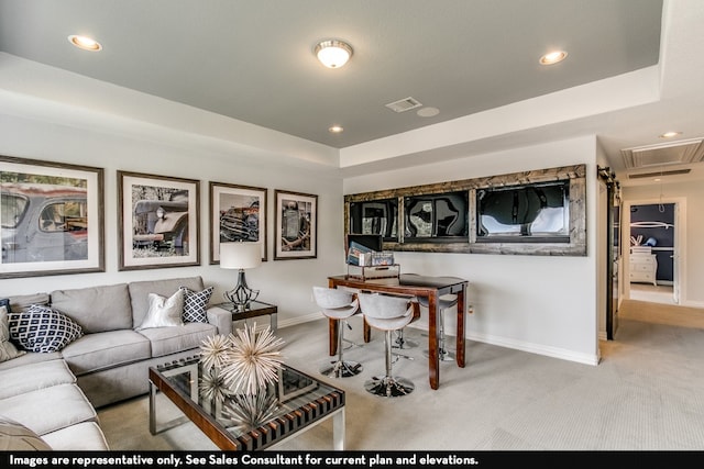 living room with carpet flooring and a raised ceiling