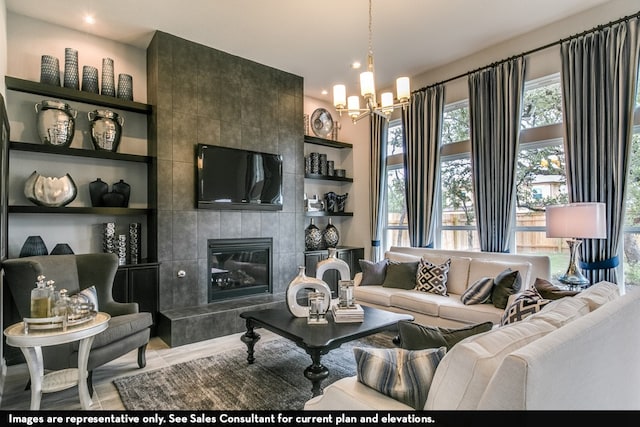 living room featuring a tile fireplace, tile walls, and a chandelier