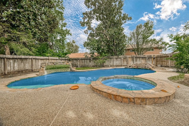 view of pool with an in ground hot tub