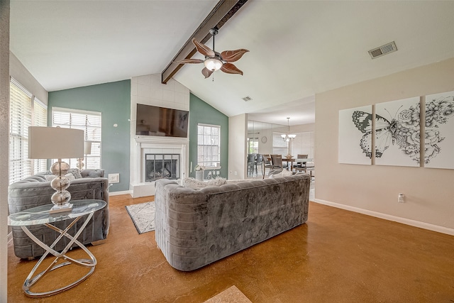 carpeted living room featuring a healthy amount of sunlight, beamed ceiling, a tiled fireplace, and ceiling fan