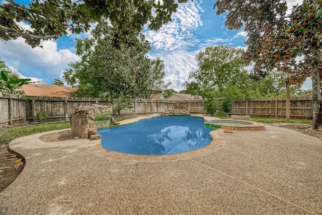 view of swimming pool with an in ground hot tub and a patio