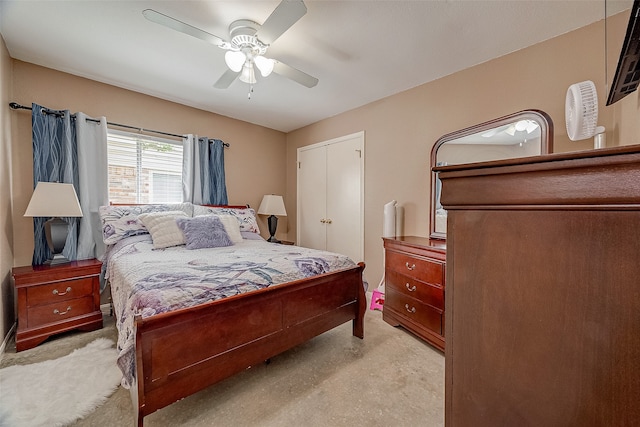 bedroom with a closet, light colored carpet, and ceiling fan